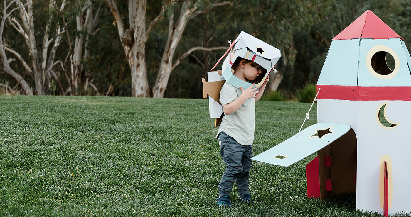 kid play with a rocket on grass