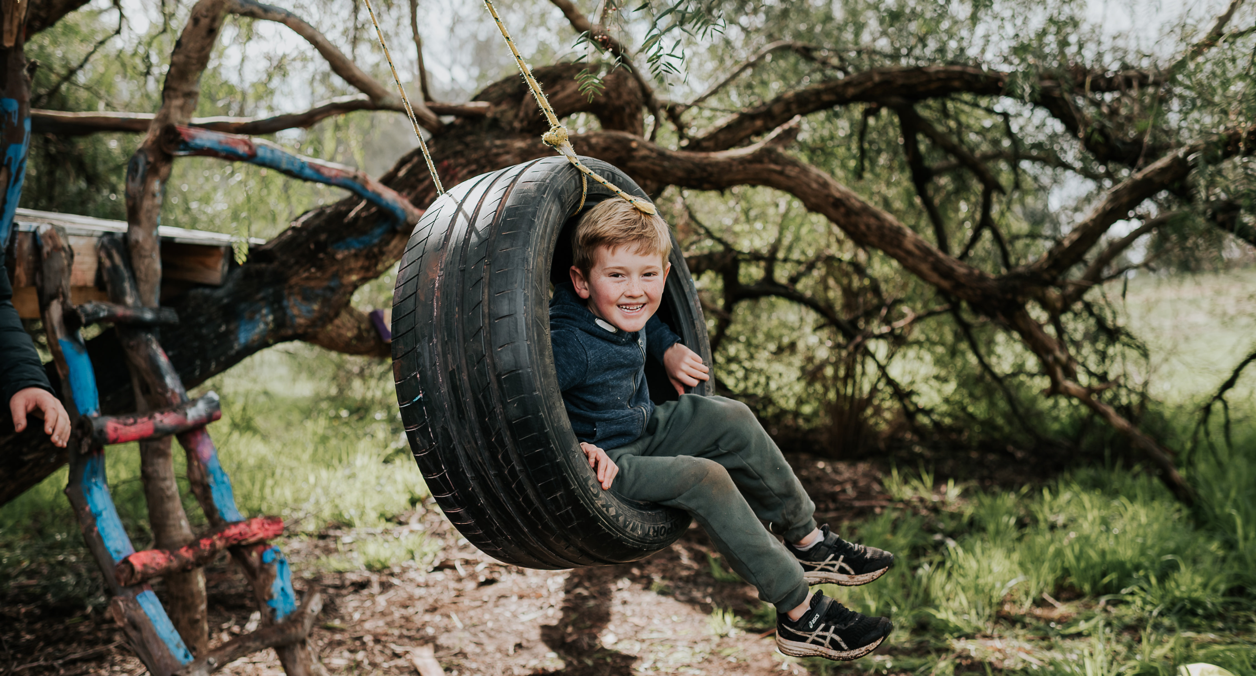 kid playing with swing tire