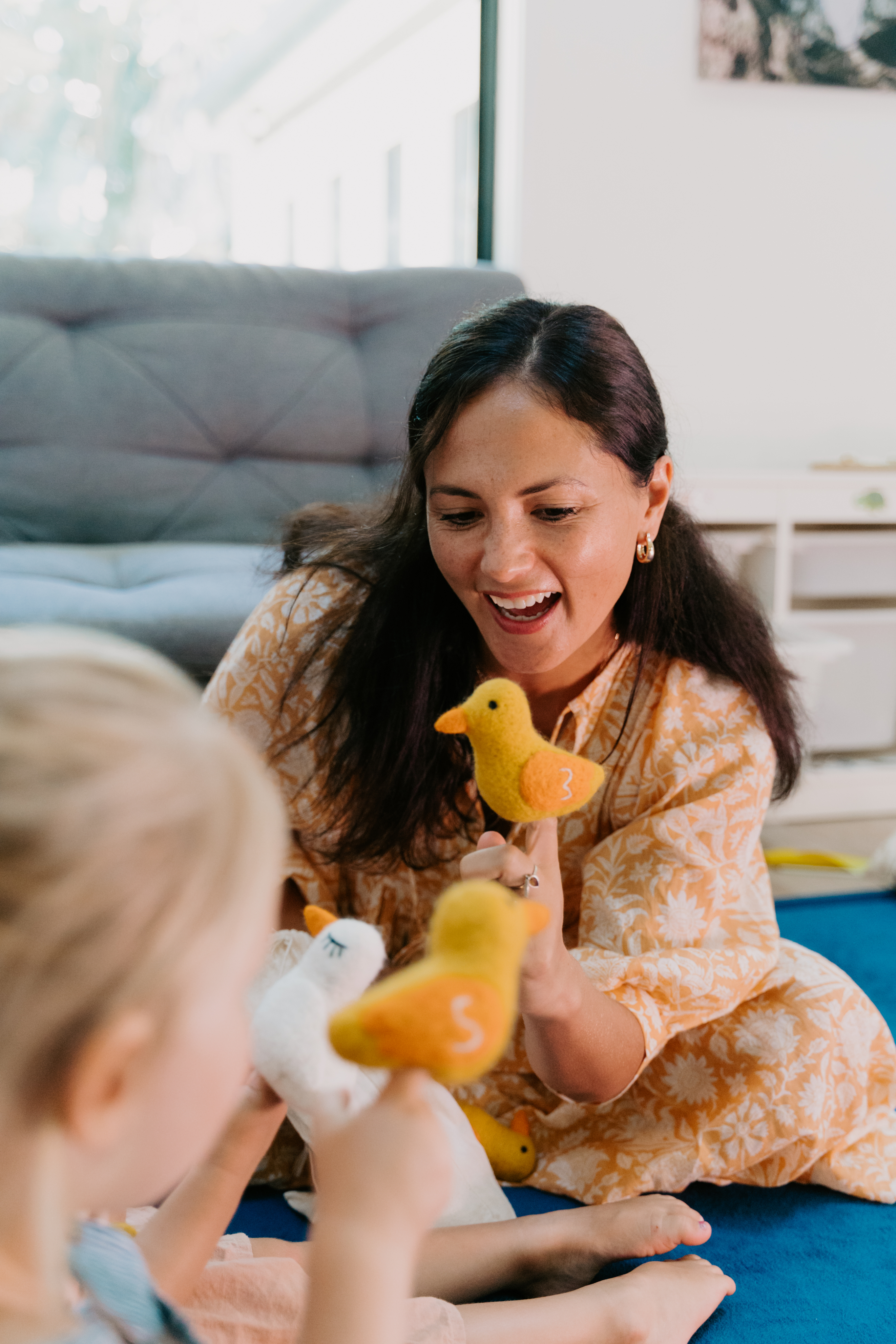 Adults playing ducks with kids