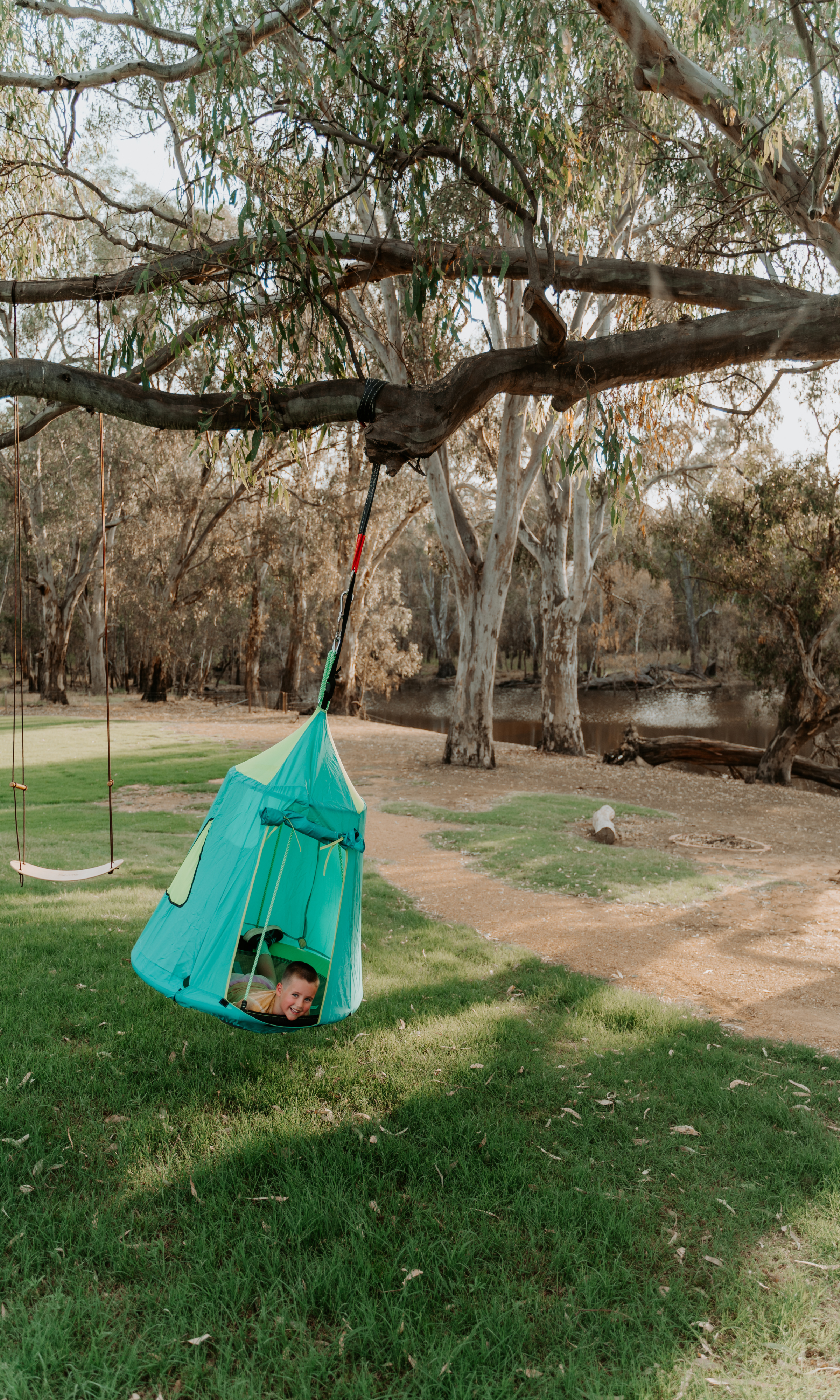 kid playing with a swinging tent