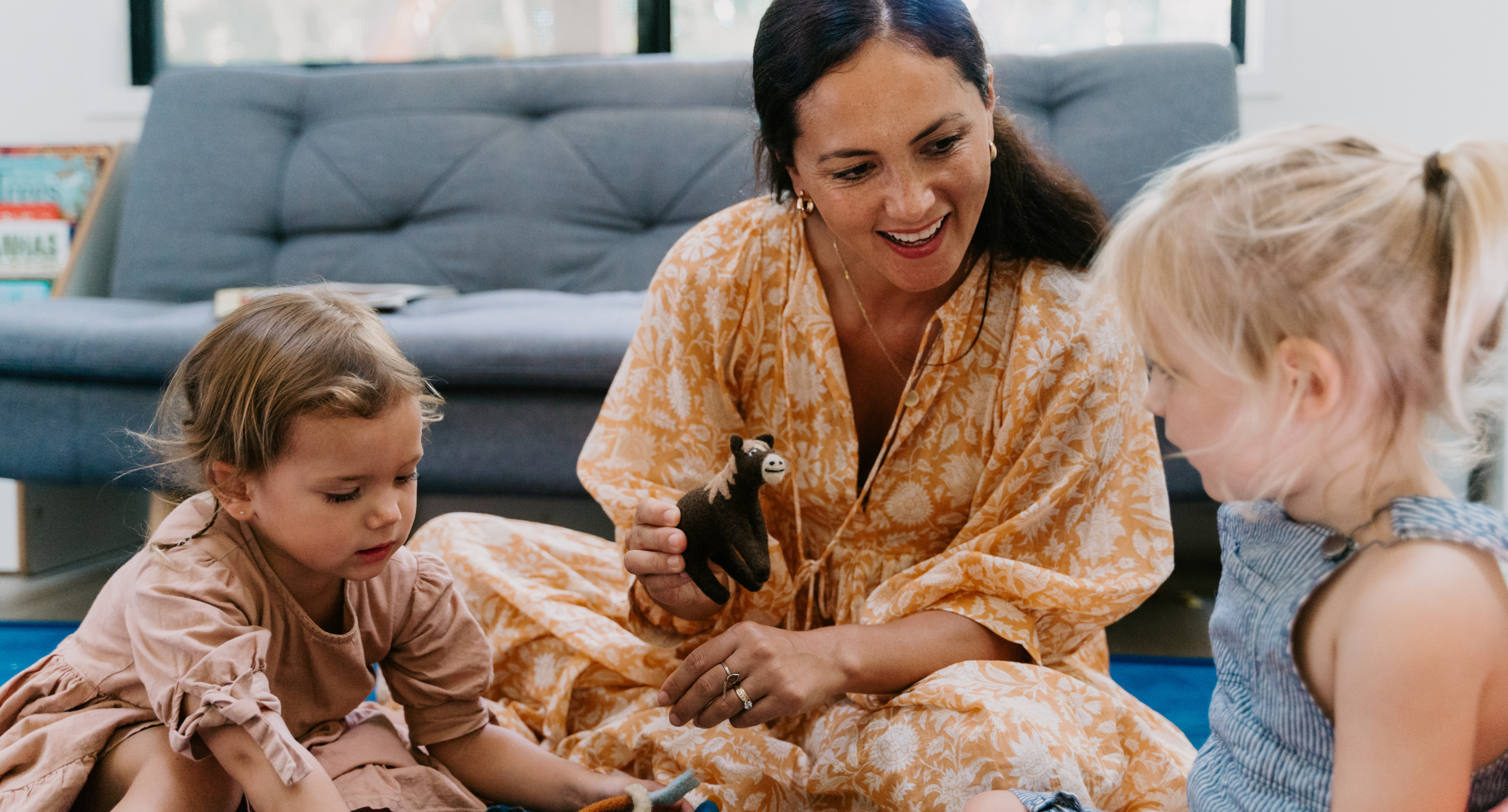 adult and two kids playing toys