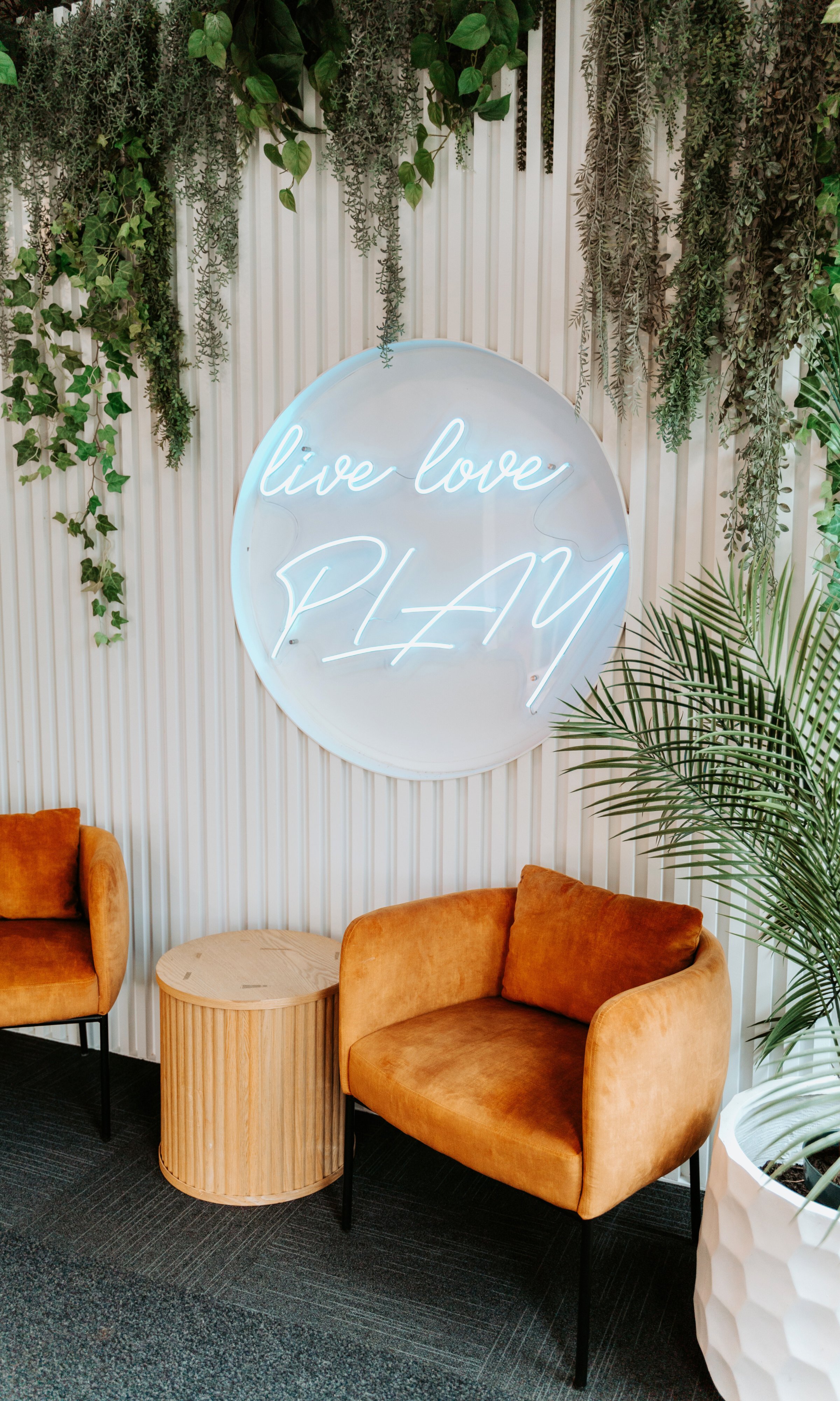 Neon sign with the words "Live, Love, Play".